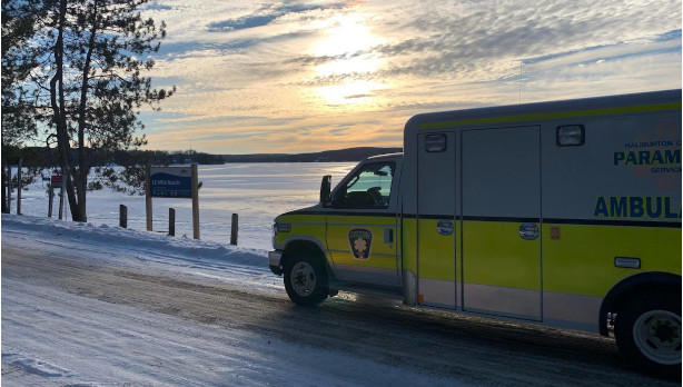 Ambulance parked by a lake