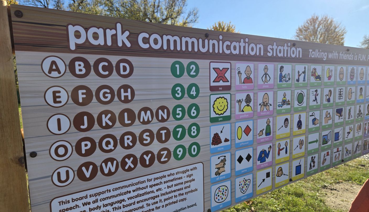 An alternative and augmentative (symbols) communication board outside in a park.