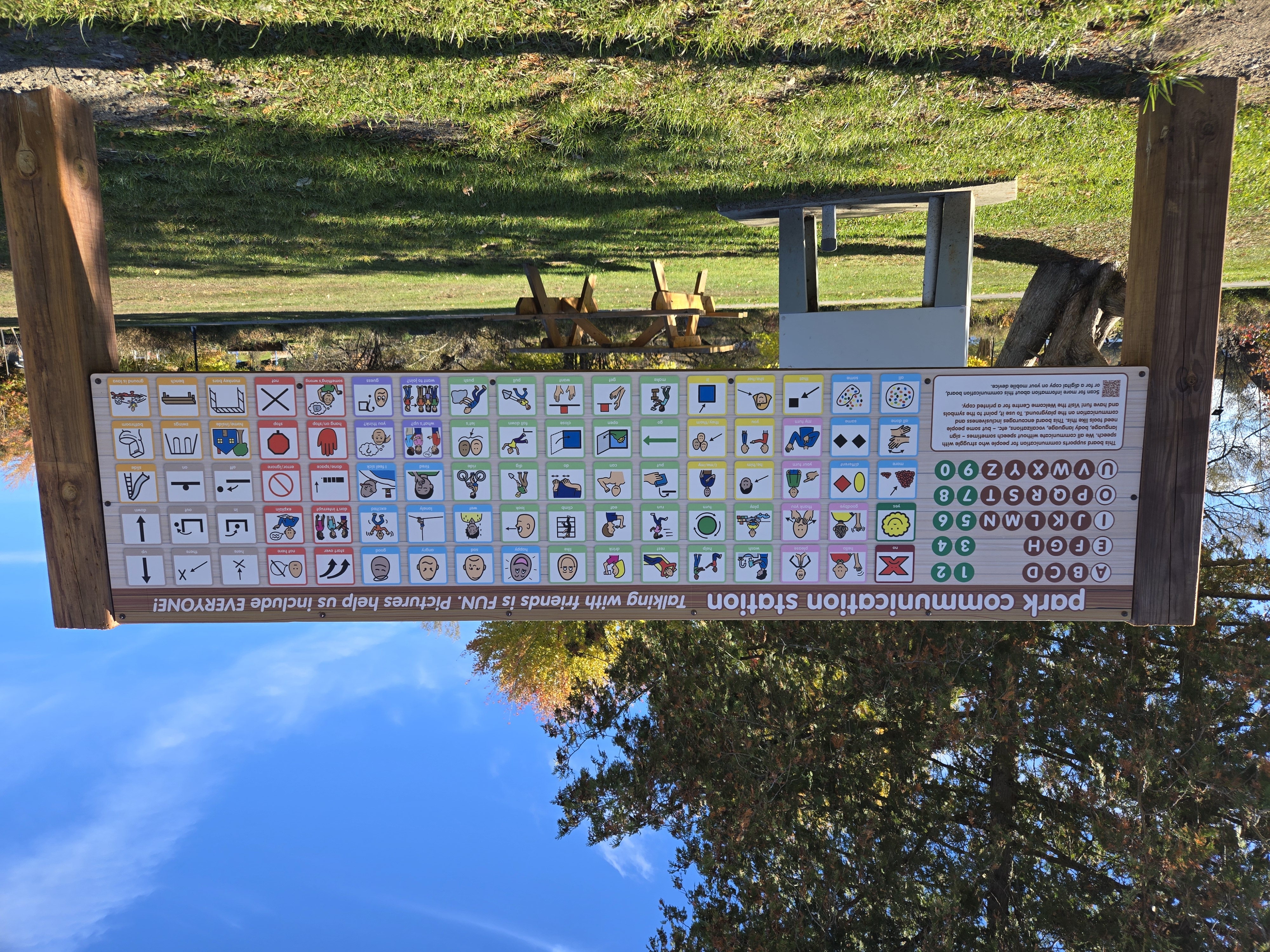 An alternative and augmentative (symbols) communication board outside in a park.