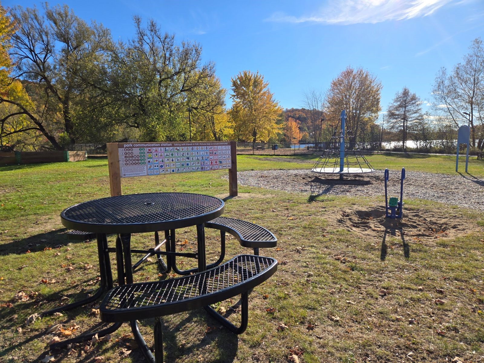 An alternative and augmentative (symbols) communication board outside in a park.